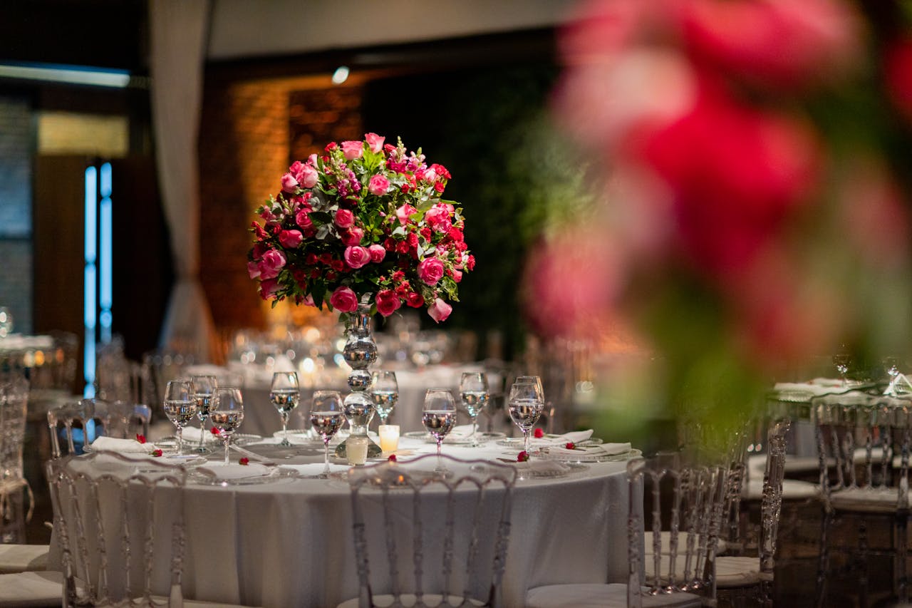 Stunning wedding venue showcasing a vibrant pink rose centerpiece on a beautifully set table.